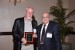 Dr. Nagib Callaos, General Chair, giving Prof. Wolfgang G. Stock a plaque "In Appreciation for Delivering a Great Keynote Address at a Plenary Session."